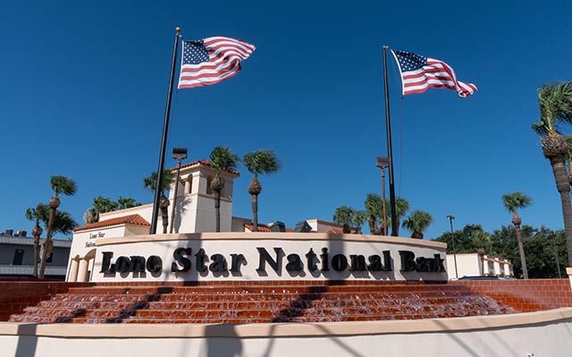 Lone Star National Bank front entrance display with American flags in the background