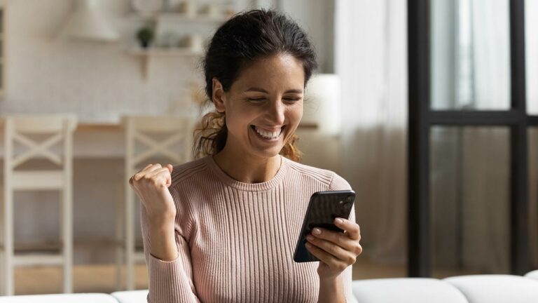 Young woman smiling using a smart phone