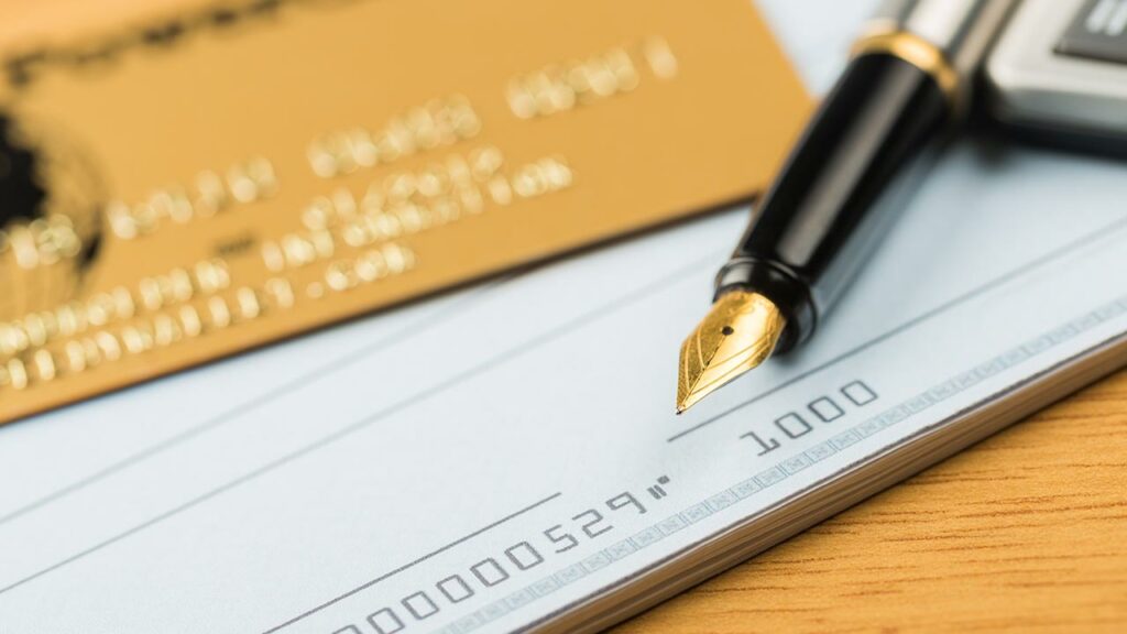 Closeup of a pen on top of a checkbook