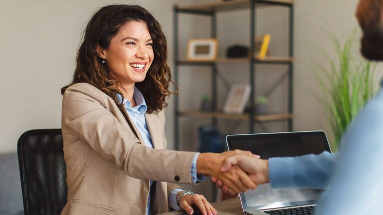 Businesswoman shaking hands with another person
