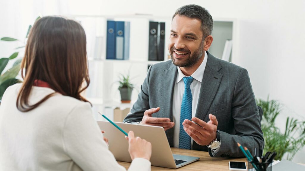 Banker speaking with a client on a laptop