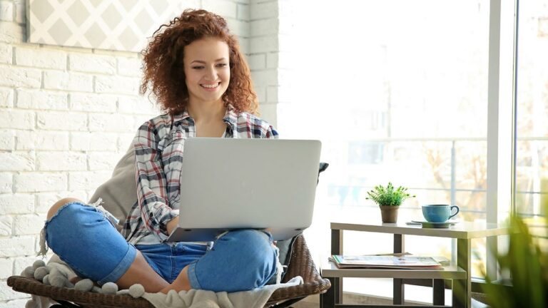 Young woman at home on her laptop